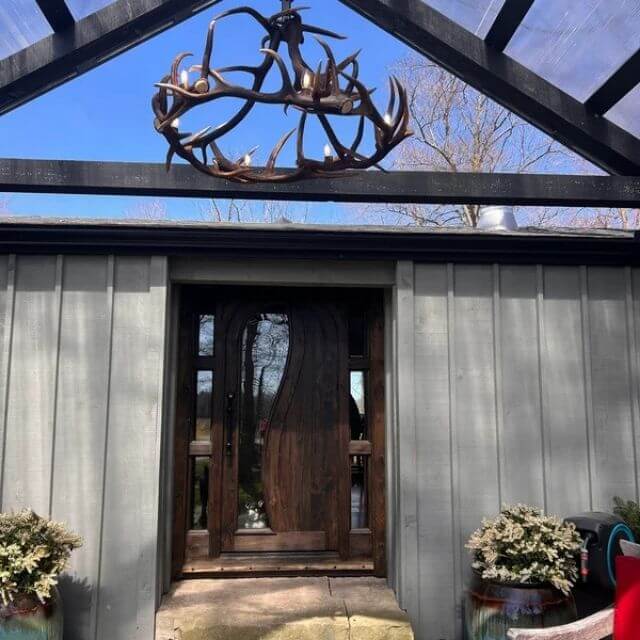 Real, round shape antler chandelier for 6 lights hanging outdoor in modern farmhouse cabin.