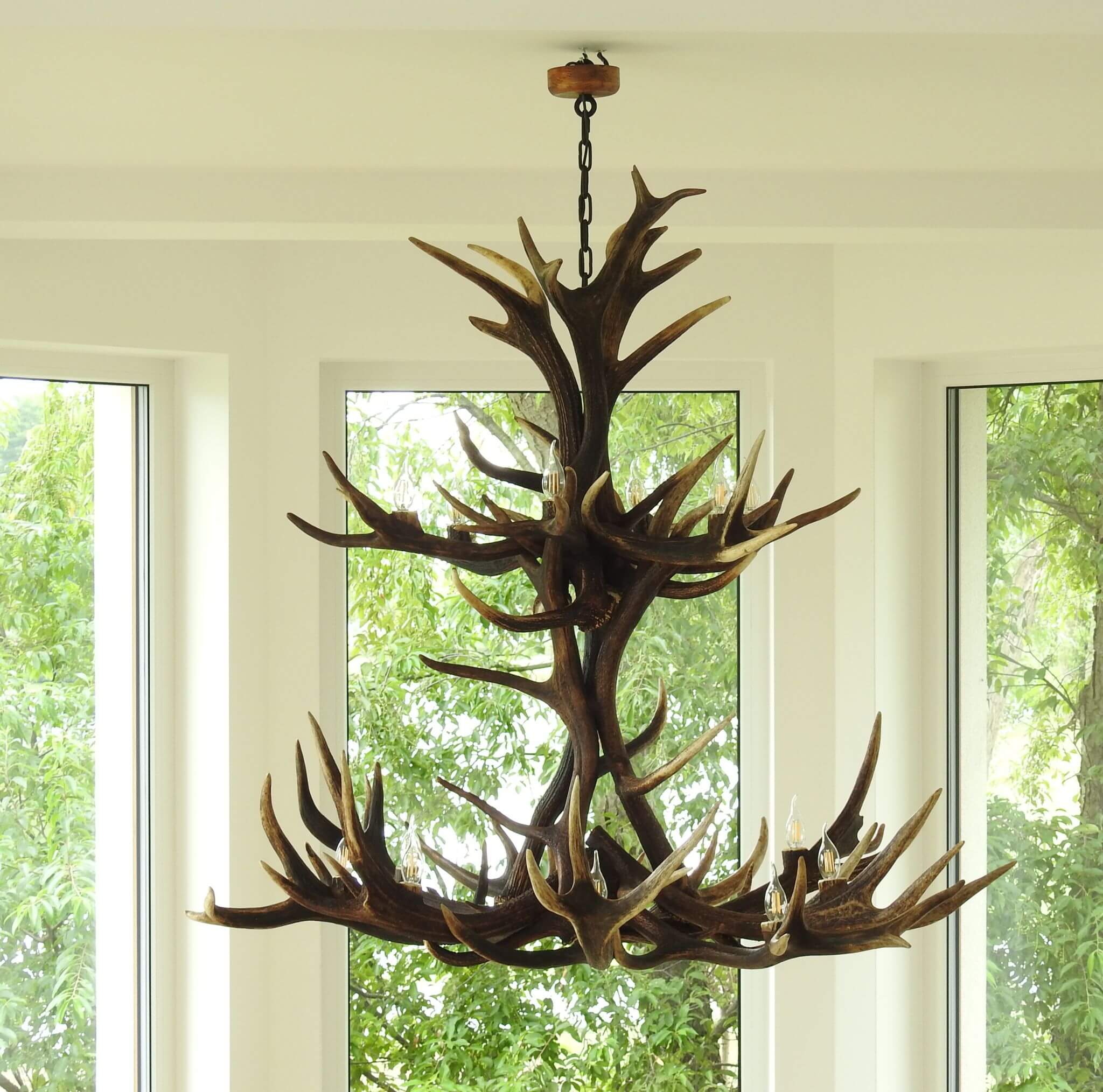 Large antler chandelier hanging on chain.