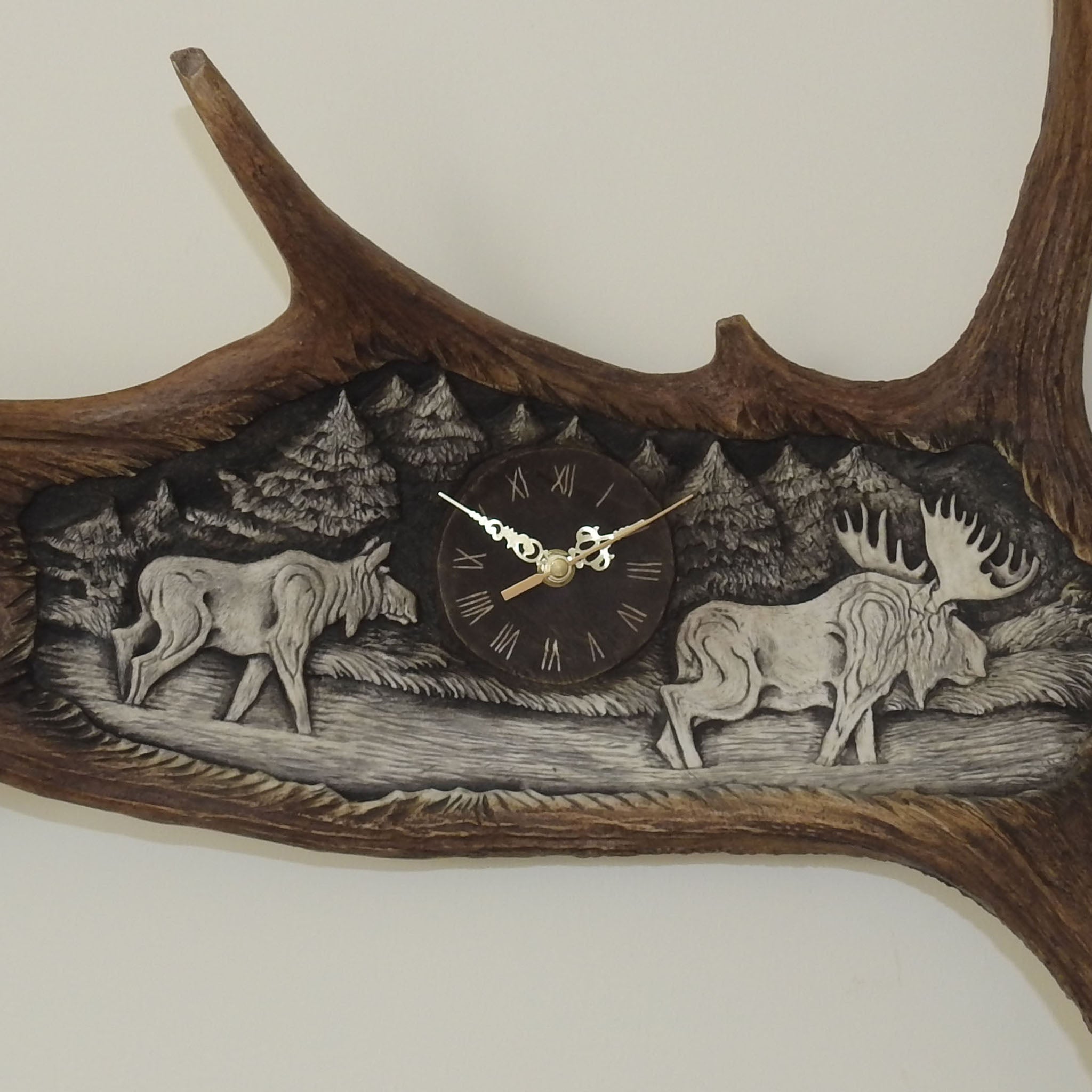 Elk shed carving shows couple of moose.