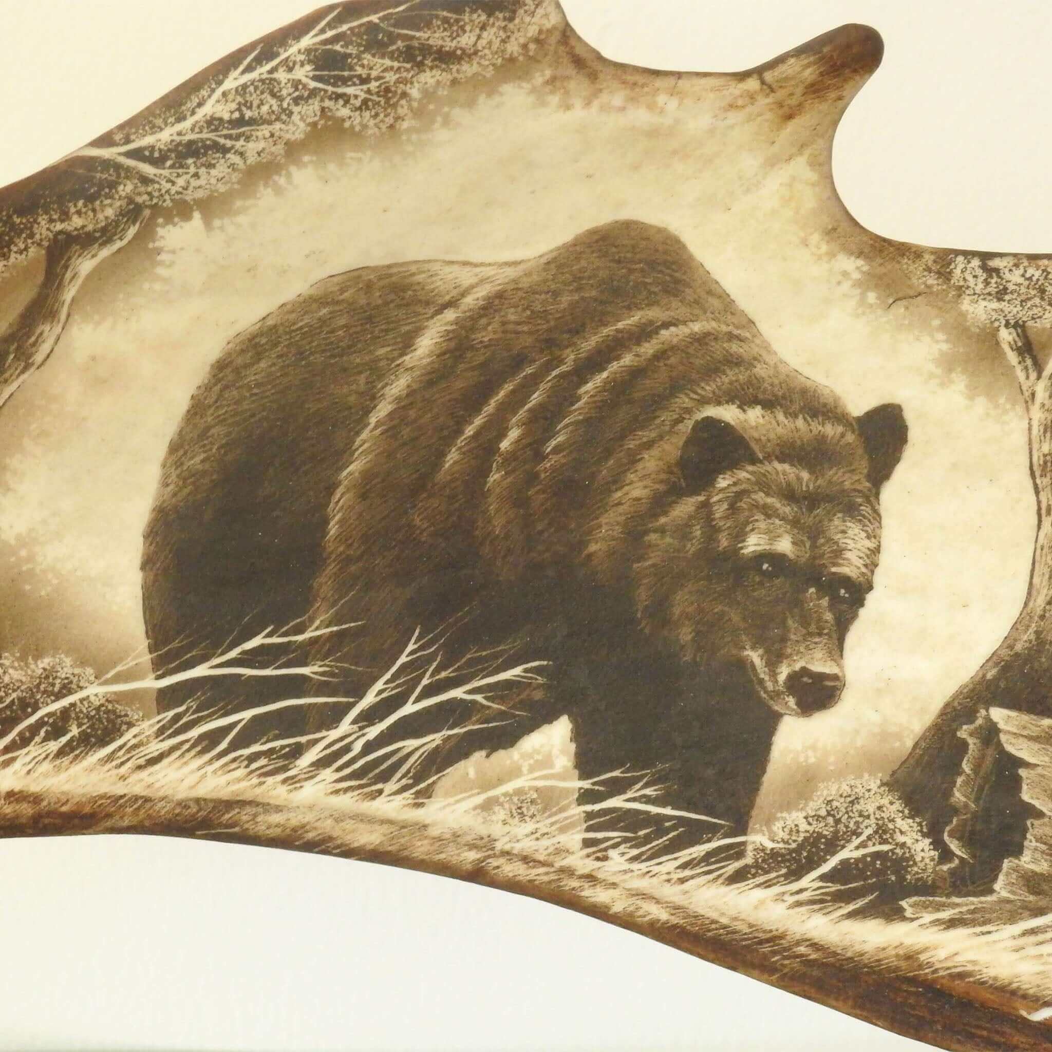 Antler carving shows bear.