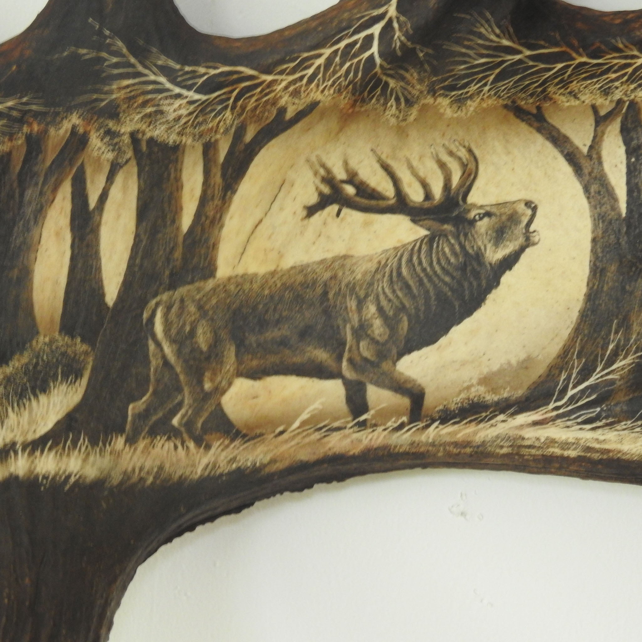 Antler carving shows deer.