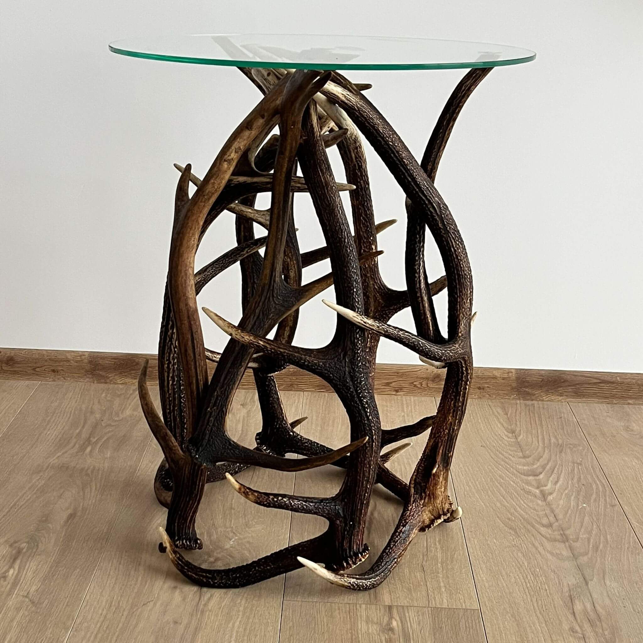 Farmhouse table with glass top, made of red deer antlers.